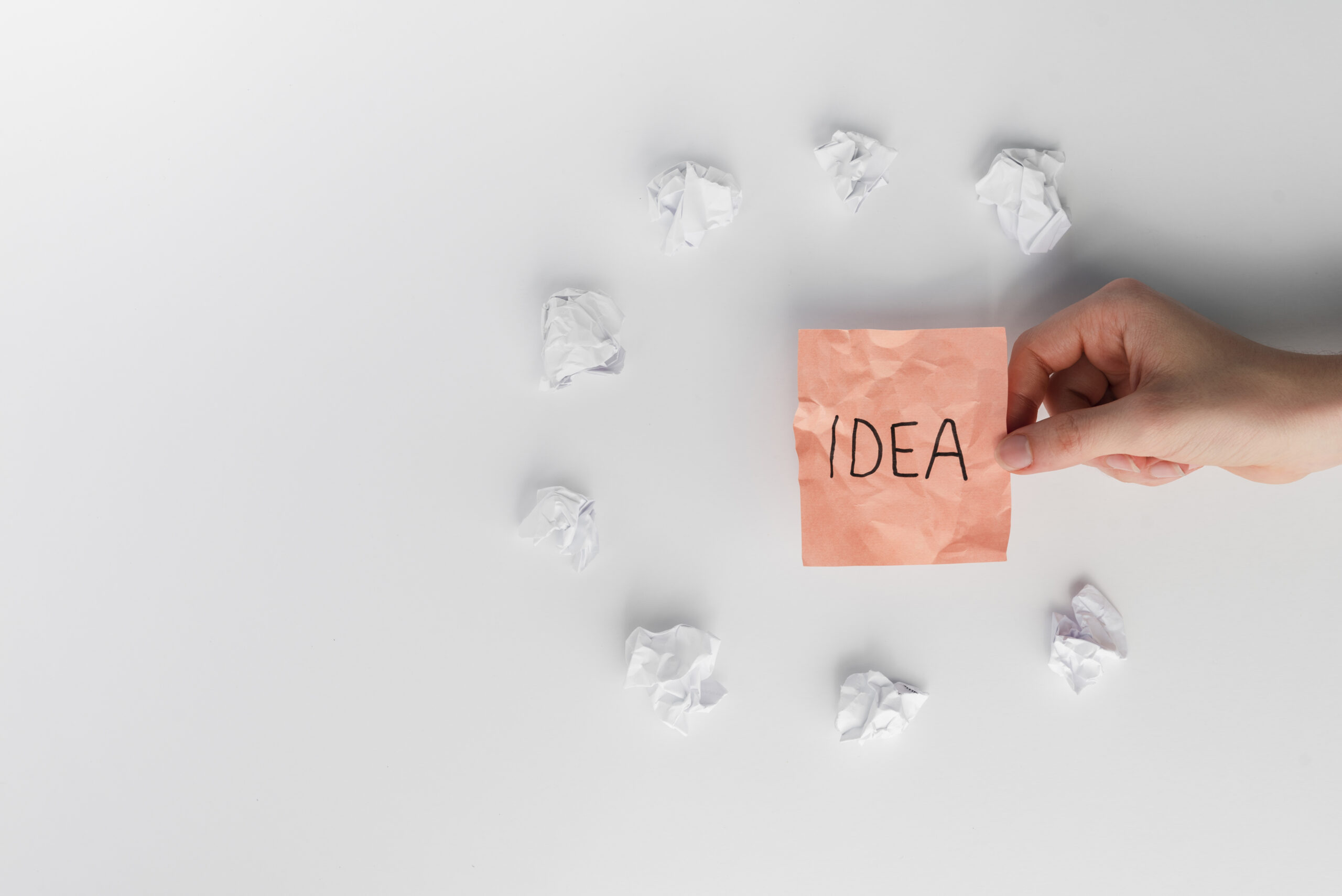 Mano sosteniendo nota adhesiva con la palabra “idea”, relacionada con la conclusión en branding y estrategia de marca.